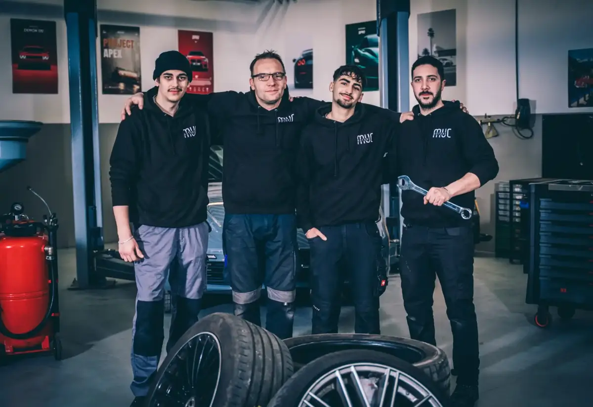 Das Werkstatt-Team von MUC Motors vor einer Hebebühne in Landshut